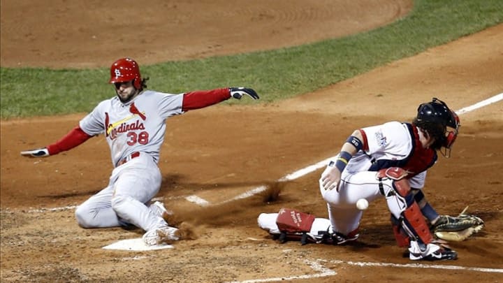 Oct 24, 2013; Boston, MA, USA; St. Louis Cardinals shortstop Pete Kozma (38) scores as the ball gets by Boston Red Sox catcher Jarrod Saltalamacchia (39) during the seventh inning of game two of the MLB baseball World Series at Fenway Park. Mandatory Credit: Mark L. Baer-USA TODAY Sports