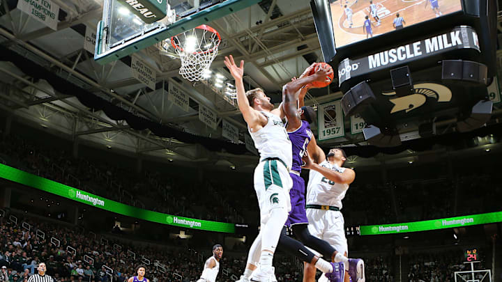 EAST LANSING, MI – JANUARY 02: Dererk Pardon #5 of the Northwestern Wildcats drives to the basket and draws a foul from Kyle Ahrens #0 of the Michigan State Spartans in the second half at Breslin Center on January 2, 2019 in East Lansing, Michigan. (Photo by Rey Del Rio/Getty Images)