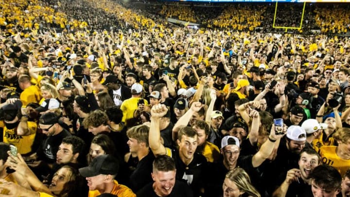 Iowa Hawkeyes fans celebrate while storming the field after beating Penn State, Saturday, Oct. 9, 2021, at Kinnick Stadium in Iowa City, Iowa. Iowa beat Penn State, 23-20.