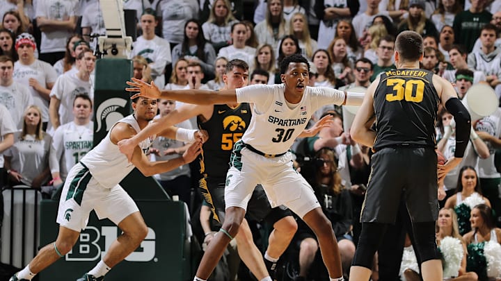 EAST LANSING, MI – FEBRUARY 25: Connor McCaffery #30 of the Iowa Hawkeyes handles the ball while defended by Marcus Bingham Jr. #30 of the Michigan State Spartans in the first half of the game at the Breslin Center on February 25, 2020 in East Lansing, Michigan. (Photo by Rey Del Rio/Getty Images)