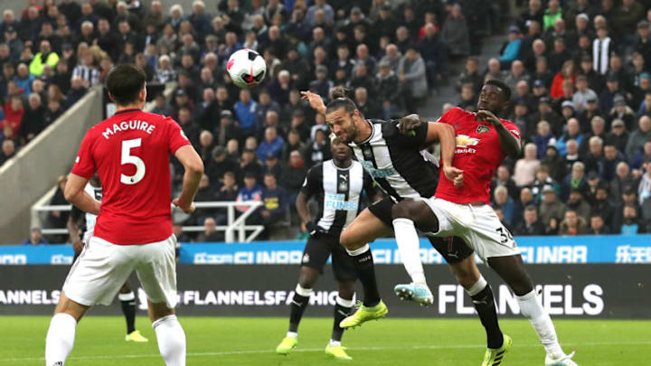 NEWCASTLE UPON TYNE, ENGLAND - OCTOBER 06: Andy Carroll of Newcastle United heads towards goal whilst under pressure from Axel Tuanzebe of Manchester United during the Premier League match between Newcastle United and Manchester United at St. James Park on October 06, 2019 in Newcastle upon Tyne, United Kingdom. (Photo by Ian MacNicol/Getty Images)