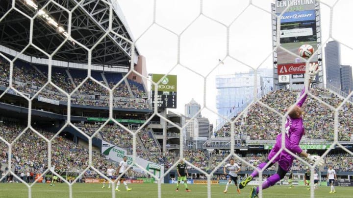 Jul 19, 2014; Seattle, WA, USA; Tottenham Hotspur goalkeeper Brad Friedel (24) jumps but misses the goal shot by Seattle Sounders FC midfielder Osvaldo Alonso (6) (not picture) during the second half at CenturyLink Field. The game was a 3-3 draw. Mandatory Credit: Steven Bisig-USA TODAY Sports