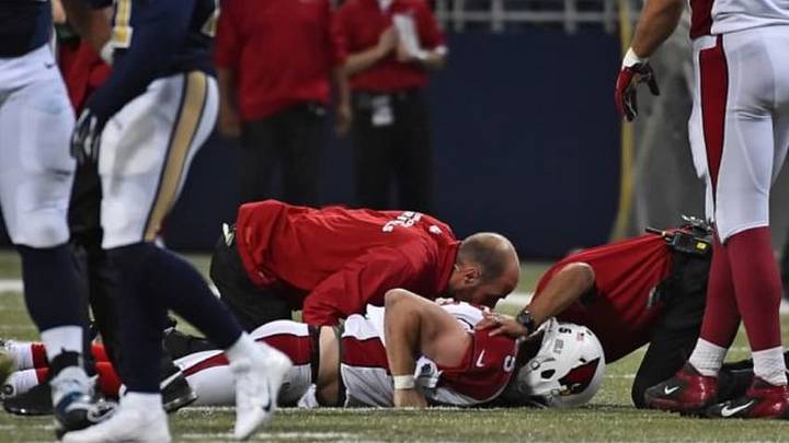 Dec 11, 2014; St. Louis, MO, USA; Team trainers attend to Arizona Cardinals quarterback Drew Stanton (5) after he is injured in the game between the St. Louis Rams and the Arizona Cardinals during the second half at the Edward Jones Dome. Mandatory Credit: Jasen Vinlove-USA TODAY Sports