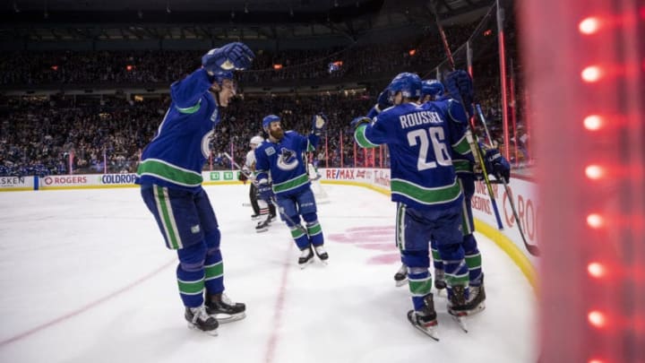 VANCOUVER, BC - FEBRUARY 20: Adam Gaudette #88 of the Vancouver Canucks celebrates his goal against goaltender Corey Crawford #50 of the Chicago Blackhawks with teammates Tyler Myers #57, Jordie Benn #4 and Antoine Roussel #26 during the second period at Rogers Arena on February 12, 2020 in Vancouver, Canada. (Photo by Ben Nelms/Getty Images)