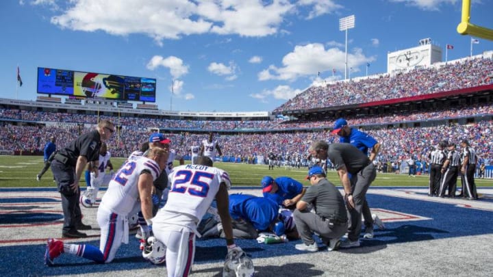 ORCHARD PARK, NY - SEPTEMBER 16: Buffalo Bills players and medical staff gather around Taiwan Jones #26 of the Buffalo Bills after he was hit without his helmet during the third quarter against the Los Angeles Chargers at New Era Field on September 16, 2018 in Orchard Park, New York. (Photo by Brett Carlsen/Getty Images)