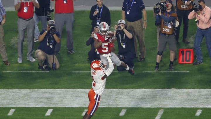 GLENDALE, ARIZONA - DECEMBER 28: Wide receiver Garrett Wilson #5 of the Ohio State Buckeyes leaps to catch a pass over defensive back Derion Kendrick #1 of the Clemson Tigers during the first half of the College Football Playoff Semifinal at the PlayStation Fiesta Bowl at State Farm Stadium on December 28, 2019 in Glendale, Arizona. (Photo by Ralph Freso/Getty Images)