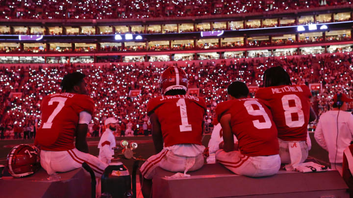 Nov 20, 2021; Tuscaloosa, Alabama, USA; Alabama Crimson Tide wide receiver Ja’Corey Brooks (7) and wide receiver Jameson Williams (1) and quarterback Bryce Young (9) and wide receiver John Metchie III (8) watch as the stadium lights turn red and fans use their cell phones during a game against the Arkansas Razorbacks at Bryant-Denny Stadium. Alabama won 42-35. Mandatory Credit: Gary Cosby Jr.-USA TODAY Sports