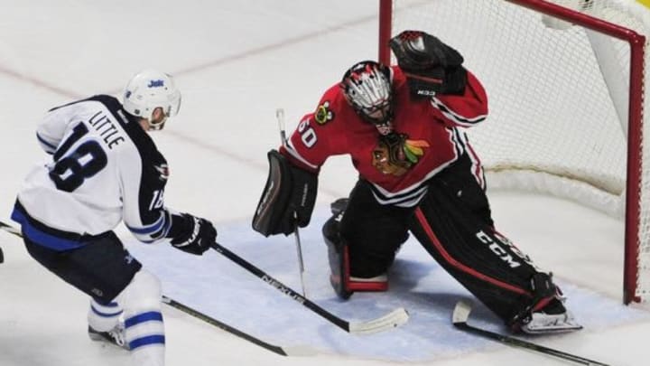 Dec 11, 2015; Chicago, IL, USA; Chicago Blackhawks goalie Corey Crawford (50) makes a save on Winnipeg Jets center Bryan Little (18) during the third period at the United Center. The Blackhawks won 2-0. Mandatory Credit: David Banks-USA TODAY Sports