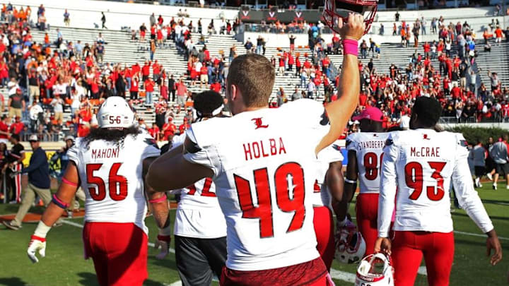 Oct 29, 2016; Charlottesville, VA, USA; Louisville Cardinals long snapper Colin Holba (49) celebrates with teammates while leaving the field after the Cardinals