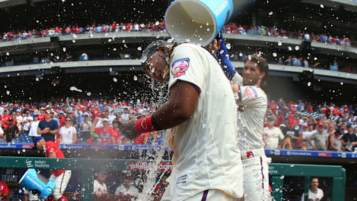 PHILADELPHIA, PA - JULY 14: Maikel Franco #7 of the Philadelphia Phillies is doused with water by teammate Bryce Harper #3 after hitting the game winning walk-off home run against the Washington Nationals during ninth inning a baseball game at Citizens Bank Park on July 14, 2019 in Philadelphia, Pennsylvania. The Phillies defeated the Nationals 4-3. (Photo by Rich Schultz/Getty Images)