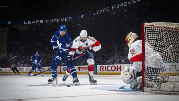 TORONTO, ON - MARCH 25: Auston Matthews #34 of the Toronto Maple Leafs goes to the net against Aaron Ekblad #5 of the Florida Panthers and Roberto Luongo #1 during the third period at the Scotiabank Arena on March 25, 2019 in Toronto, Ontario, Canada. (Photo by Mark Blinch/NHLI via Getty Images)