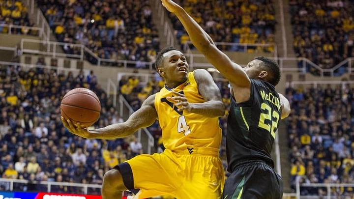 Feb 6, 2016; Morgantown, WV, USA; West Virginia Mountaineers guard Daxter Miles Jr. (4) shoots over Baylor Bears guard King McClure (22) during the second half at the WVU Coliseum. Mandatory Credit: Ben Queen-USA TODAY Sports
