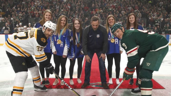 ST. PAUL, MN - MARCH 25: The 2018 U.S. Olympic Women's Ice Hockey Team takes part in a ceremonial puck drop along with Mikko Koivu #9 of the Minnesota Wild and Patrice Bergeron #37 of the Boston Bruins prior to the game at the Xcel Energy Center on March 25, 2018 in St. Paul, Minnesota. (Photo by Bruce Kluckhohn/NHLI via Getty Images)
