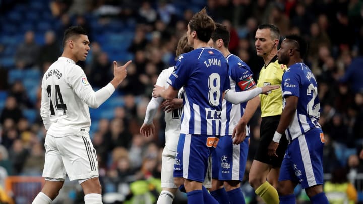 MADRID, SPAIN – FEBRUARY 3: Carlos Casemiro of Real Madrid argues with Mubarak Wakaso of Deportivo Alaves during La Liga soccer match between Real Madrid and Deportivo Alaves at Santiago Bernabeu Stadium in Madrid, Spain on February 3, 2019.(Photo by Burak Akbulut/Anadolu Agency/Getty Images)