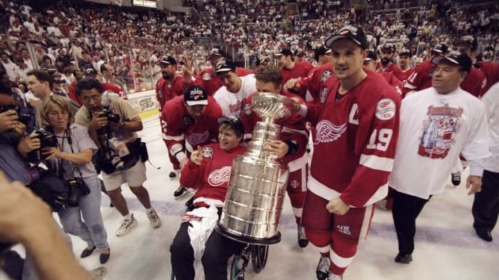 16 Jun 1998: Former member of the Detroit Red Wing Vladimir Konstantinov poses with the Stanley cup and former teammates during the Stanley Cup Finals game against the Washington Capitals at the MCI Center in Washington, D. C.. The Red Wings defeated the Capitals 4-1. Mandatory Credit: Robert Laberge /Allsport