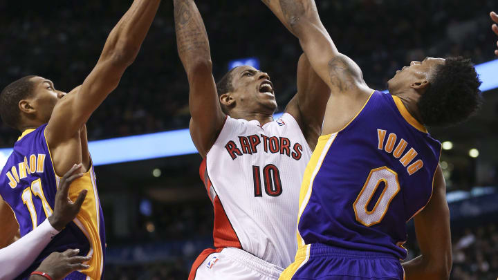 Toronto, ON – January 19 – In second half action, Toronto Raptors shooting guard DeMar DeRozan (10) runs into some tough defense on his way to the hoop courtesy of Los Angeles Lakers small forward Nick Young (0) and Los Angeles Lakers small forward Wesley Johnson (11).The Toronto Raptors lost to the LA Lakers 112-106 at the Air Canada Centre on Sunday afternoon. They blew a 17 point lead.January 19, 2014. (Richard Lautens/Toronto Star via Getty Images)