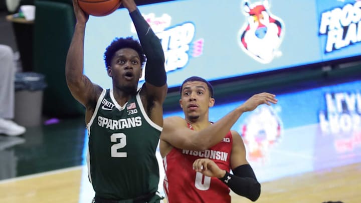 Dec 25, 2020; East Lansing, MI, USA; Michigan State Spartans guard Rocket Watts (2) drives Friday, Dec. 25, 2020, against Wisconsin Badgers guard D’Mitrik Trice (0) during second half action at the Breslin Center in East Lansing. Mandatory Credit: Kirthmon F. Dozier-USA TODAY Sports