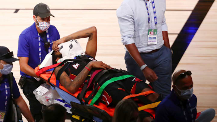 LAKE BUENA VISTA, FLORIDA - AUGUST 14: Derrick Jones Jr. #5 of the Miami Heat covers his face with a towel while he is taken off the court by medical personnel after colliding with Goga Bitadze #88 of the Indiana Pacers during the second half of a NBA basketball game at AdventHealth Arena at ESPN Wide World Of Sports Complex on August 14, 2020 in Lake Buena Vista, Florida. NOTE TO USER: User expressly acknowledges and agrees that, by downloading and or using this photograph, User is consenting to the terms and conditions of the Getty Images License Agreement. (Photo by Kim Klement - Pool/Getty Images)