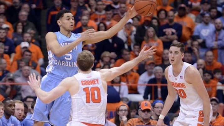 Jan 9, 2016; Syracuse, NY, USA; North Carolina Tar Heels guard Marcus Paige (5) makes a pass as Syracuse Orange guard Trevor Cooney (10) defends during the second half of a game at the Carrier Dome. North Carolina won 84-73. Mandatory Credit: Mark Konezny-USA TODAY Sports