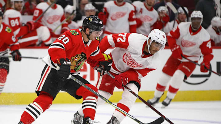 CHICAGO, IL - SEPTEMBER 25: Andreas Athanasiou #72 of the Detroit Red Wings and Brandon Saad #20 of the Chicago Blackhawks battle for the puck during a preseason game at the United Center on September 25, 2018 in Chicago, Illinois. The Red Wings defeated the Blackhawks 8-6. (Photo by Jonathan Daniel/Getty Images)