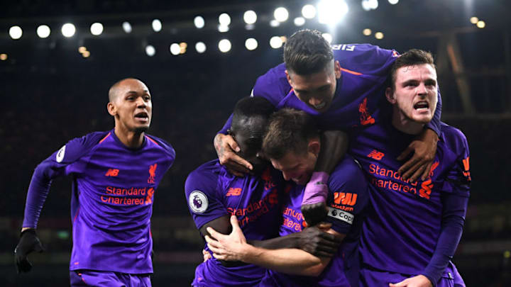 LONDON, ENGLAND - NOVEMBER 03: James Milner of Liverpool celebrates with Sadio Mane, Andy Robertson, Roberto Firmino and Fabinho of Liverpool after he scores his sides first goal during the Premier League match between Arsenal FC and Liverpool FC at Emirates Stadium on November 3, 2018 in London, United Kingdom. (Photo by Michael Regan/Getty Images)
