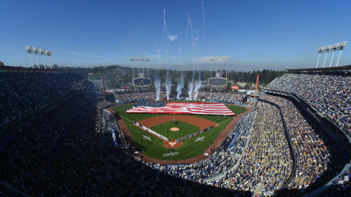 LOS ANGELES, CA - MARCH 29: A large United States flag is held up by members of the United States armed forces in the outfield during the national anthem during a baseball game between San Francisco Giants and Los Angeles Dodgers on Opening Day at Dodger Stadium on March 29, 2018 in Los Angeles, California. (Photo by Kevork Djansezian/Getty Images)