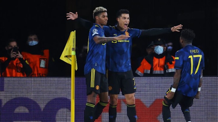 Manchester United's Portuguese forward Cristiano Ronaldo (C) celebrates with teammates after scoring a goal during the UEFA Champions League Group F football match between Villarreal CF and Manchester United, at La Ceramica stadium in Vila-real on November 23, 2021. (Photo by JOSE JORDAN / AFP) (Photo by JOSE JORDAN/AFP via Getty Images)