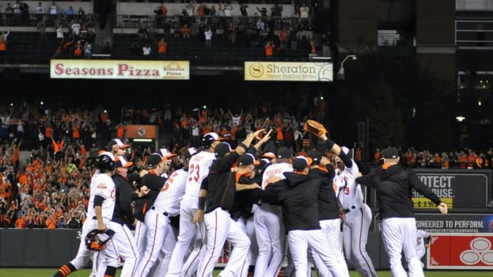 Sep 16, 2014; Baltimore, MD, USA; Baltimore Orioles players celebrate after clinching the AL East title after a game against the Toronto Blue Jays at Oriole Park at Camden Yards. The Orioles defeated the Jays 8-2. Mandatory Credit: Joy R. Absalon-USA TODAY Sports