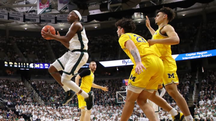 EAST LANSING, MICHIGAN - JANUARY 05: Cassius Winston #5 of the Michigan State Spartans drives the basket past Brandon Johns Jr. #23 of the Michigan Wolverines during the first half at Breslin Center on January 05, 2020 in East Lansing, Michigan. (Photo by Gregory Shamus/Getty Images)