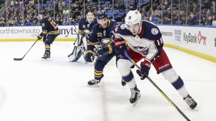 BUFFALO, NY - JANUARY 11: Columbus Blue Jackets Center Pierre-Luc Dubois (18) skates with the puck as Buffalo Sabres Left Wing Johan Larsson (22) defends during the Columbus Blue Jackets and Buffalo Sabres NHL game on January 11, 2018, at KeyBank Center in Buffalo, NY. (Photo by John Crouch/Icon Sportswire via Getty Images)