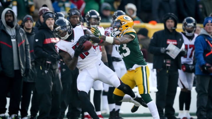GREEN BAY, WISCONSIN - DECEMBER 09: Julio Jones #11 of the Atlanta Falcons makes a catch while being guarded by Jaire Alexander #23 of the Green Bay Packers in the first quarter at Lambeau Field on December 09, 2018 in Green Bay, Wisconsin. (Photo by Dylan Buell/Getty Images)
