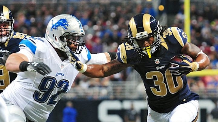 Dec 13, 2015; St. Louis, MO, USA; St. Louis Rams running back Todd Gurley (30) stiff arms Detroit Lions defensive tackle Haloti Ngata (92) during the second half at the Edward Jones Dome. The Rams defeated the Lions 21-14. Mandatory Credit: Jeff Curry-USA TODAY Sports
