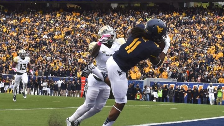 Oct 18, 2014; Morgantown, WV, USA; West Virginia Mountaineers wide receiver Kevin White (11) catches a touchdown as Baylor Bears cornerback Xavien Howard (4) defends during the first quarter at Milan Puskar Stadium. Mandatory Credit: Tommy Gilligan-USA TODAY Sports