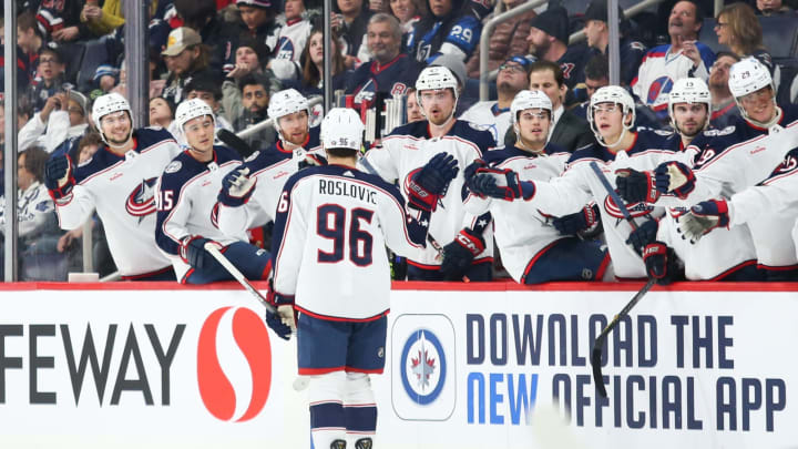 Dec 2, 2022; Winnipeg, Manitoba, CAN; Columbus Blue Jackets forward Jack Roslovic (96) is congratulated by his team mates on his goal against the Winnipeg Jets during the first period at Canada Life Centre. Mandatory Credit: Terrence Lee-USA TODAY Sports