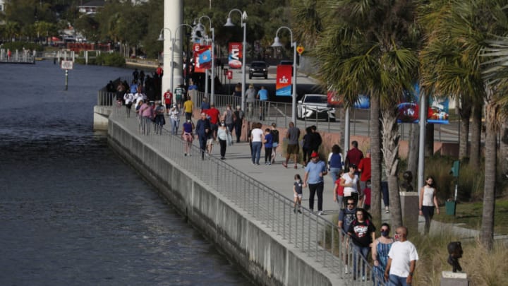 TAMPA, FL - JANUARY 30: National Football League fans walk along the Riverwalk in downtown Tampa ahead of Super Bowl LV during the COVID-19 pandemic on January 30, 2021 in Tampa, Florida. The Tampa Bay Buccaneers will play the Kansas City Chiefs in Raymond James Stadium for Super Bowl LV on February 7. (Photo by Octavio Jones/Getty Images)