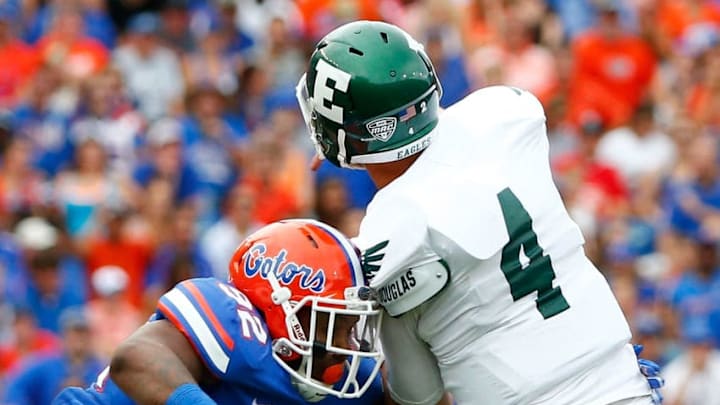 GAINESVILLE, FL - SEPTEMBER 06: Gerald Willis #92 of the Florida Gators pressures Brogan Roback #4 of the Eastern Michigan Eagles during the game at Ben Hill Stadium on September 6, 2014 in Gainesville, Florida. (Photo by Sam Greenwood/Getty Images)