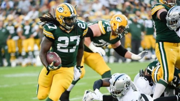 Aug 22, 2014; Green Bay, WI, USA; Green Bay Packers running back Eddie Lacy (27) gets around Oakland Raiders safety Charles Woodson (24) to gain yards in the 1st quarter during preseason game at Lambeau Field. Mandatory Credit: Benny Sieu-USA TODAY Sports Aug 22, 2014; Green Bay, WI, USA; Green Bay Packers running back Eddie Lacy (27) gets around Oakland Raiders safety Charles Woodson (24) to gain yards in the 1st quarter during preseason game at Lambeau Field. Mandatory Credit: Benny Sieu-USA TODAY Sports