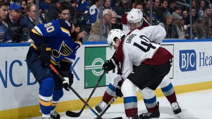 ST. LOUIS, MO - DECEMBER 16: Ryan O'Reilly #90 of the St. Louis Blues battles Samuel Girard #49 of the Colorado Avalanche for the puck at Enterprise Center on December 16, 2019 in St. Louis, Missouri. (Photo by Joe Puetz/NHLI via Getty Images)