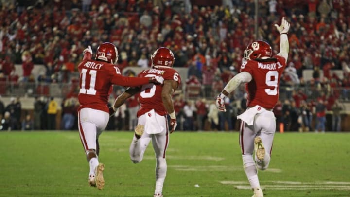 NORMAN, OK - NOVEMBER 10: Cornerback Parnell Motley #11, cornerback Tre Brown #6 and linebacker Kenneth Murray #9 of the Oklahoma Sooners celebrate stopping the Oklahoma State Cowboys on their last series of the game at Gaylord Family Oklahoma Memorial Stadium on November 10, 2018 in Norman, Oklahoma. Oklahoma defeated Oklahoma State 48-47. (Photo by Brett Deering/Getty Images)