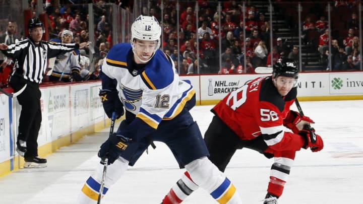 NEWARK, NJ - MARCH 30: Zach Sanford #12 of the St. Louis Blues skates as Kevin Rooney #58 of the New Jersey Devils defends during an NHL hockey game at the Prudential Center in Newark, New Jersey. Blues won 3-2. (Photo by Paul Bereswill/Getty Images)