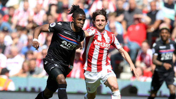 STOKE ON TRENT, ENGLAND - MAY 05: Wilfried Zaha of Crystal Palace and Joe Allen of Stoke City battle for the ball during the Premier League match between Stoke City and Crystal Palace at Bet365 Stadium on May 5, 2018 in Stoke on Trent, England. (Photo by Nigel Roddis/Getty Images)