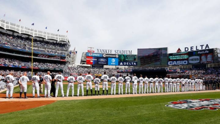 NEW YORK, NY - APRIL 10: (NEW YORK DAILIES OUT) The New York Yankees and the Tampa Bay Rays line up for the national anthem during Opening Day ceremonies at Yankee Stadium on April 10, 2017 in the Bronx borough of New York City. The Yankees defeated the Rays 8-1. (Photo by Jim McIsaac/Getty Images)