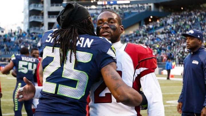 Nov 23, 2014; Seattle, WA, USA; Arizona Cardinals cornerback Patrick Peterson (21) talks with Seattle Seahawks cornerback Richard Sherman (25) following a 19-3 Seattle victory at CenturyLink Field. Mandatory Credit: Joe Nicholson-USA TODAY Sports