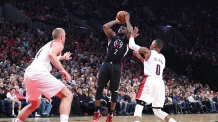 Oct 27, 2016; Portland, OR, USA; Los Angeles Clippers guard Raymond Felton (2) shoots over Portland Trail Blazers forward Mason Plumlee (24) and Damian Lillard (0) in the first at Moda Center. Mandatory Credit: Jaime Valdez-USA TODAY Sports