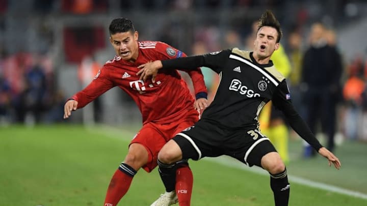 Bayern Munich's Colombian midfielder James Rodriguez (L) and Ajax's Argentine defender Nicolas Tagliafico vie for the ball during the UEFA Champions League Group E football match between Bayern Munich and Ajax Amsterdam in Munich, southern Germany, on October 2, 2018. (Photo by Christof STACHE / AFP) (Photo credit should read CHRISTOF STACHE/AFP/Getty Images)