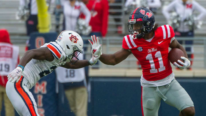 Oct 24, 2020; Oxford, Mississippi, USA; Mississippi Rebels wide receiver Dontario Drummond (11) blocks a tackle from Auburn Tigers defensive back Trey Elston (22) at Vaught-Hemingway Stadium. Mandatory Credit: Justin Ford-USA TODAY Sports