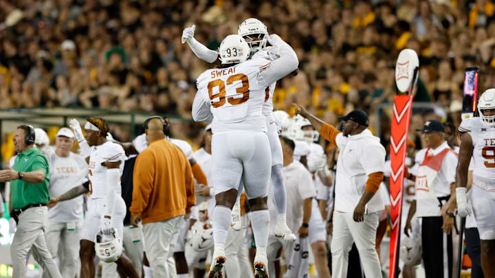 WACO, TEXAS – SEPTEMBER 23: T’Vondre Sweat #93 of the Texas Longhorns is congratulated by Jahdae Barron #23 after a tackle on fourth down against the Baylor Bears in the first half at McLane Stadium on September 23, 2023 in Waco, Texas. (Photo by Tim Warner/Getty Images)