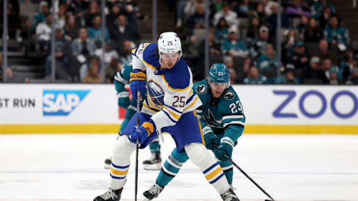 SAN JOSE, CALIFORNIA - FEBRUARY 18: Owen Power #25 of the Buffalo Sabres and Oskar Lindblom #23 of the San Jose Sharks go for the puck in the second period at SAP Center on February 18, 2023 in San Jose, California. (Photo by Ezra Shaw/Getty Images)