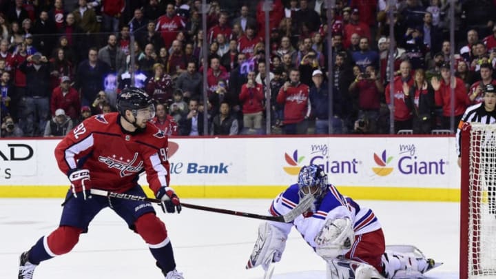 WASHINGTON, DC - MARCH 28: Henrik Lundqvist #30 of the New York Rangers makes a save against Evgeny Kuznetsov #92 of the Washington Capitals on a penalty shot in the first period at Capital One Arena on March 28, 2018 in Washington, DC. (Photo by Patrick McDermott/NHLI via Getty Images)