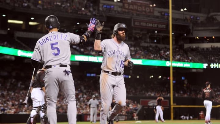 Apr 30, 2016; Phoenix, AZ, USA; Colorado Rockies center fielder Charlie Blackmon (19) slaps hands with Colorado Rockies right fielder Carlos Gonzalez (5) after scoring a run in the third inning against the Arizona Diamondbacks at Chase Field. Mandatory Credit: Joe Camporeale-USA TODAY Sports